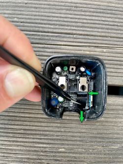 Opened plug housing showing internal components with highlighted arrows.