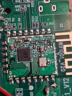 PCB of Xiaomei Fish Feeder Device Close-up of the PCB from a Xiaomei Fish Feeder showing traces, an integrated circuit, and markings.