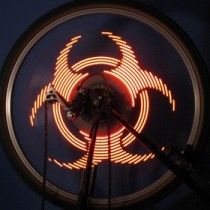 Orange LED segments on a circular rim forming a biohazard-like symbol