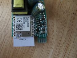 Close-up of an electronic module with visible components including a transformer and capacitors.