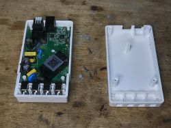 Disassembled Sonoff THR320D Thermostat Interior of a disassembled Sonoff THR320D thermostat with visible electronic components.