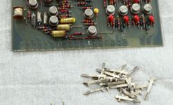 Section of a circuit board with electronic components and loose metal contacts