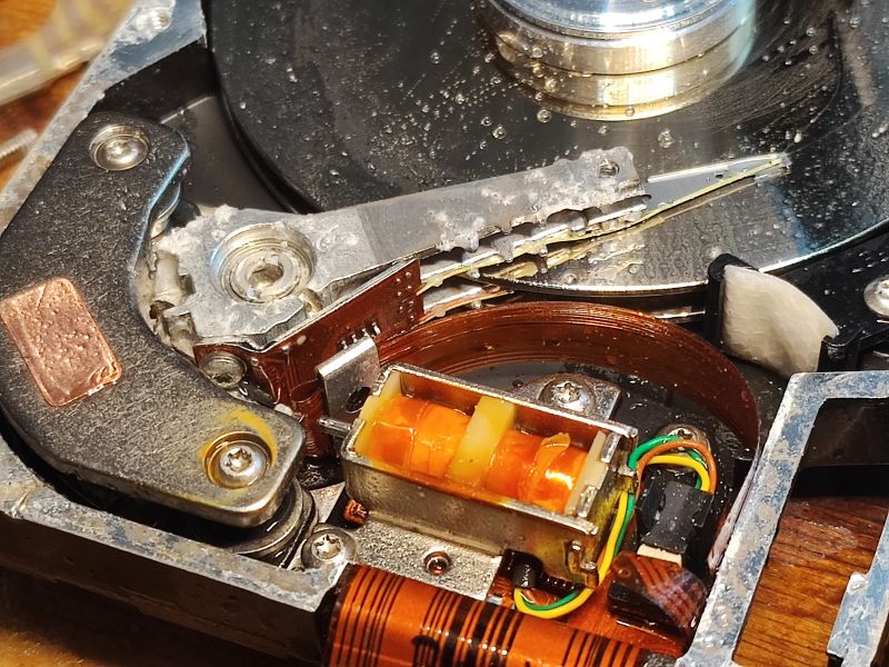 Interior of a Flood-Damaged Hard Drive Interior of a hard drive showing signs of moisture and damage.