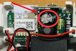 Close-up of the interior of an electronic device with a highlighted capacitor.