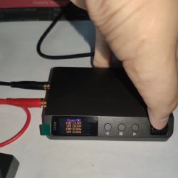 Close-up of DP100 power supply with cables and settings screen