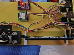 Electronic board with multiple colorful wires and modules.