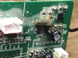 Close-up of a PCB section with electronic components and white residue