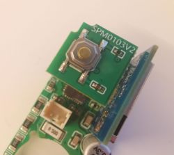 Circuit Board SPM0103V2 with Button Close-up of a circuit board with a button labeled SPM0103V2.