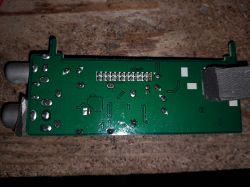 Bottom view of PCB tuner module with RF connectors and solder pin rows