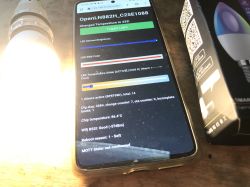 Controlling a modified LED bulb via web interface Smartphone showing a web interface for controlling a modified LED bulb with LN882H module, next to a glowing bulb and its packaging.