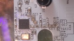 Close-up of a PCB with an IC, SMD components, and printed R and C reference markings