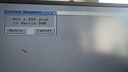 Error message on a computer screen indicating no DOS disk in device DH0.