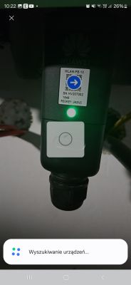 Huawei device with a QR label and button on the casing, showing a green LED light.