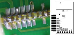 Close-up of a circuit board with visible pins and a labeled connection diagram.