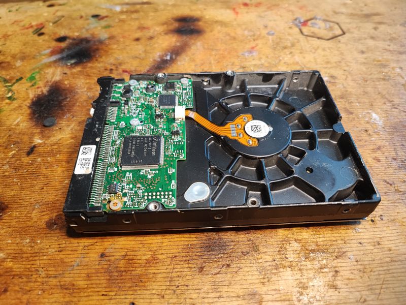 HDD with Exposed Electronics Close-up of an HDD with visible PCB and electronic components.