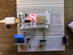 Electronic circuit on a breadboard with a NiceMCU module and temperature sensors.