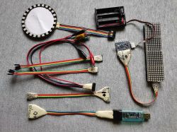 Zestaw samodzielnie wykonanych kabli i modułów elektronicznych na szarej tkaninie