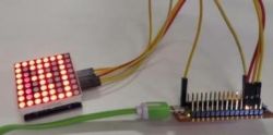 LED Matrix Module and Microcontroller LED matrix module connected to a microcontroller with wires.