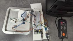 Prototype setup with electronic components on breadboards with wires and a power adapter.