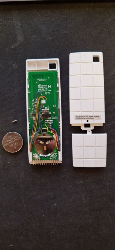 Interior of RF Remote with Soldered Wires Opened RF remote with exposed PCB and wires soldered to pins.