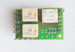 Green PCB with three white relays; the top-right relay is circled in red