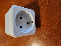 Emax 8774 Energy Monitoring Socket White Emax 8774 energy monitoring socket on a wooden surface