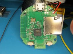PCB with Integrated Circuit and MicroSD Slot A printed circuit board with electronic components and a microSD card slot.