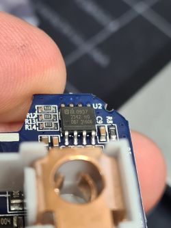 Close-up of a circuit board with a visible integrated circuit and soldered components.