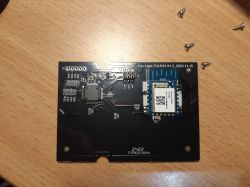 PCB with CB3S Module and TuyaMCU PCB with CB3S module and TuyaMCU chip on a wooden surface.