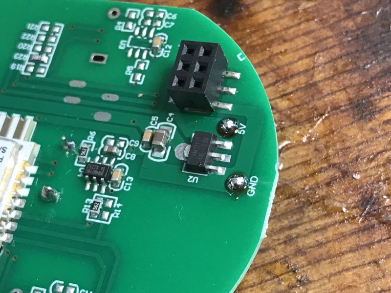 Close-up of a PCB with GND and 5V markings and a 4-pin connector visible