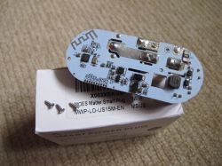 MOES Smart Plug PCB PCB of a MOES smart plug with power measurement on a box.