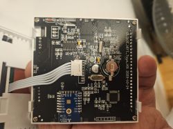 TVT31 thermostat circuit board with TUYA Wi-Fi module and ribbon cable visible.