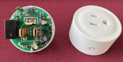 Disassembled smart socket: green XLD01 PCB next to a white housing with a power button