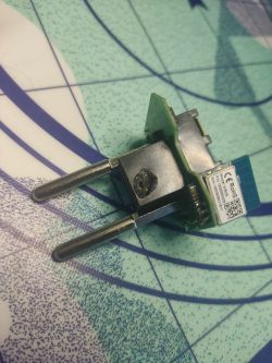 Damaged electronic plug with visible soldering mark.