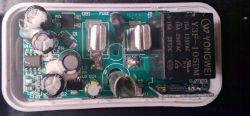 Opened KMC smart plug with visible electrical components, including capacitors and a relay.