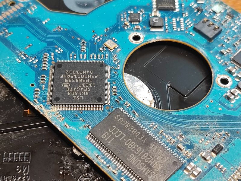 Close-up of a damaged hard drive PCB Close-up of a hard drive PCB with visible signs of moisture.