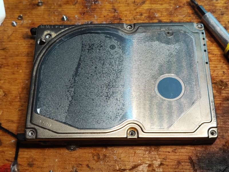 Flooded HDD Hard Drive Flooded HDD hard drive case lying on a table.