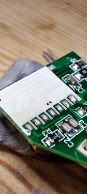 Close-up of a circuit board with several electronic components and traces on its surface.
