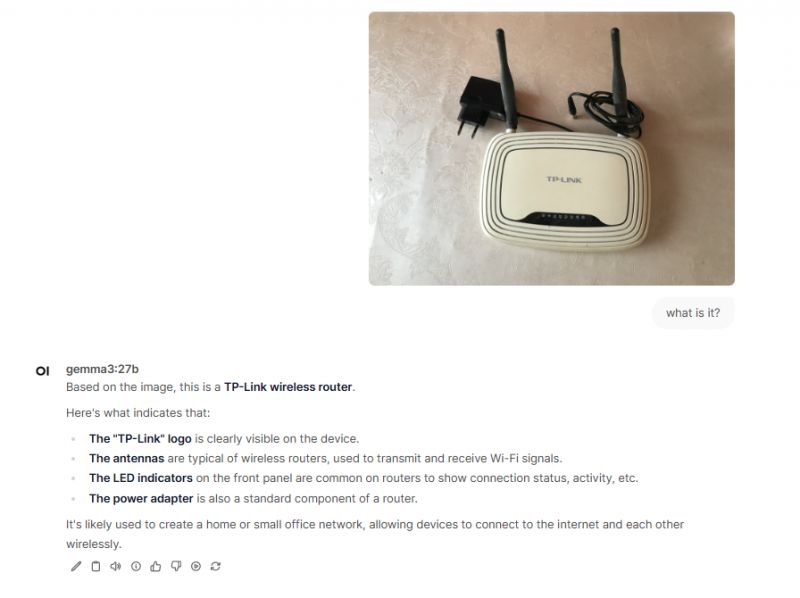 TP-Link Router The image shows a white TP-Link router with two black antennas.