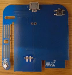 PCB board with blue laminate featuring micro USB port and soldering pads.