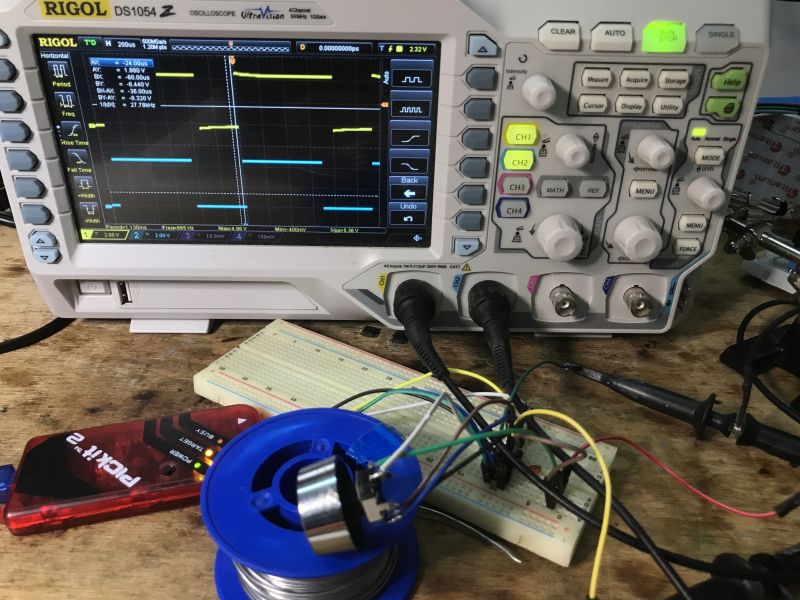 Rigol DS1054Z oscilloscope connected to encoder and microcontroller on breadboard