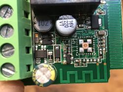 Close-up of a PCB with capacitors, an inductor, and screw terminals