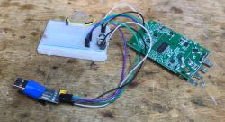 Sonoff PCB board with connected wiring and a breadboard.