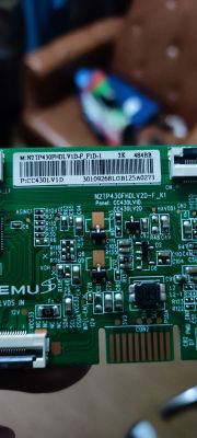 Close-up of a T-CON board with model and serial number markings.