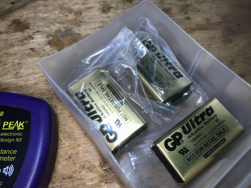 GP Ultra 9V Batteries and Measuring Device GP Ultra 9V batteries in a plastic box next to a measuring device.