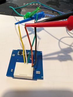 PCB with Wiring for Module Flashing PCB with attached cables in various colors.