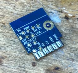 WiFi Module Printed Circuit Board on Wood Surface Printed circuit board with markings on a wooden surface.