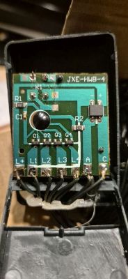 Zbliżenie na płytkę elektroniczną oznaczoną jako JXE-HWB-4 ze stykami L1 do L4, które mają być połączone z „-”.