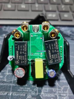 Electronic Component Circuit Board Printed circuit board with relays and capacitors against a keyboard background.