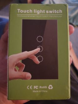 Packaging of a touch light switch with an illustration of a finger touching the panel.